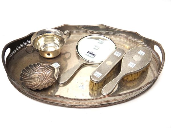 Silver and silver mounted wares, comprising; a hand mirror, a hairbrush and a similar clothes brush, London 1926 and 1927, a twin handled christening