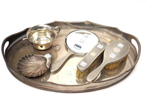 Silver and silver mounted wares, comprising; a hand mirror, a hairbrush and a similar clothes brush, London 1926 and 1927, a twin handled christening