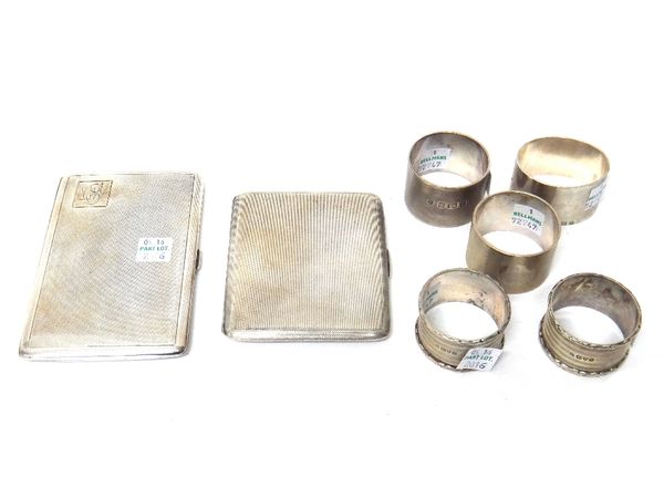 Silver, comprising; two rectangular cigarette cases, with engine turned decoration, Birmingham 1929 and Birmingham 1944, a pair of napkin rings, Londo