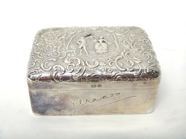 A late Victorian silver rectangular hinge lidded trinket box, decorated with two dancing figures within a border of scrolls, engraved to the front Ele