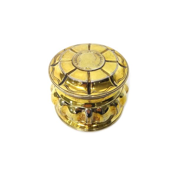 A Victorian silver gilt hinge lidded circular box, the body with lobed decoration, in the 17th century taste, the hinged lid mounted with a Charles II