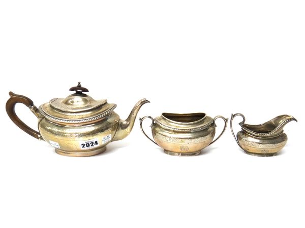 A Victorian silver composite three piece tea set, comprising; a teapot, London 1879, a twin handled sugar bowl and a milk jug, London 1878, each piece