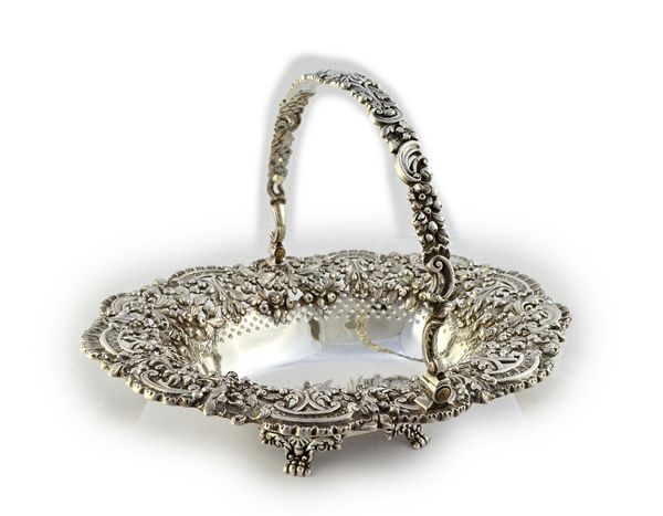 A George IV silver swing-handled basket by Robert Gainsford, Sheffield 1824, shaped oval form, the sides die-stamped with highly elaborate floral swag