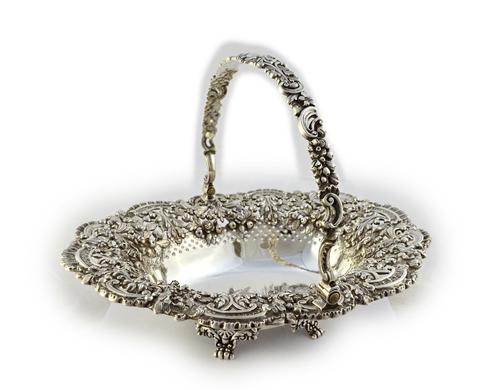 A George IV silver swing-handled basket by Robert Gainsford, Sheffield 1824, shaped oval form, the sides die-stamped with highly elaborate floral swag