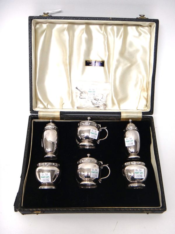 A silver six piece condiment set, comprising; two mustard pots, two salts and two pepperettes, each decorated with a border of Celtic design, Birmingh