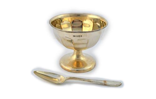 A set of six silver grapefruit bowls, each of circular form with faceted decoration, Sheffield 1936 and a set of six silver grapefruit spoons, Sheffie