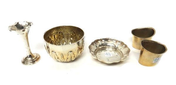 Silver, comprising; a Victorian sugar bowl, London 1883, a pair of oval spill holders, London 1907, a shaped circular dish and a small trumpet shaped