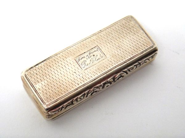 A silver rectangular hinge lidded snuff box, gilt within, the cover and the base engine turned, presentation inscribed Birmingham 1829, 49 gms.