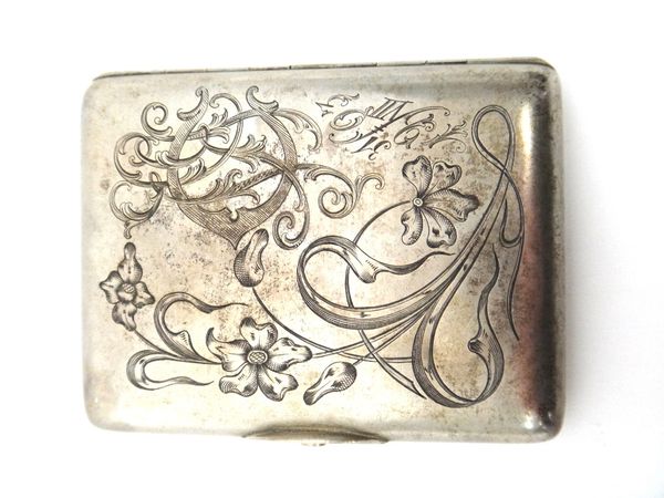 A Russian rectangular cigarette case, gilt within, the front engraved with a monogram, a floral spray and with the date 31.VII.1903, the back presenta