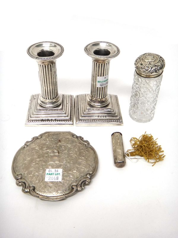 A pair of Victorian silver candlesticks, each designed as a fluted column, on a stepped square base, decorated with beaded borders, Birmingham 1899, h