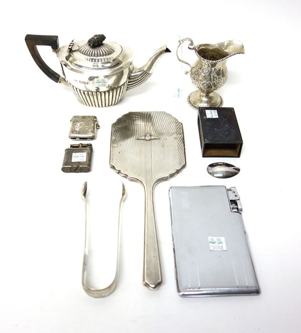 Silver, comprising; an oval teapot with partly fluted decoration, Chester 1907, a cream jug with floral and foliate embossed decoration, within gadroo