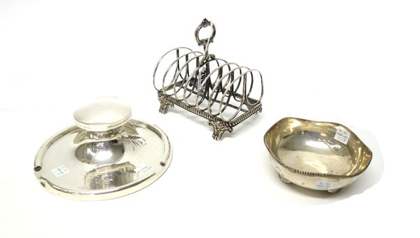 A Victorian silver seven bar toastrack, with a loop shaped handle, raised on four scrolling feet, London 1841, a silver circular inkstand, presentatio