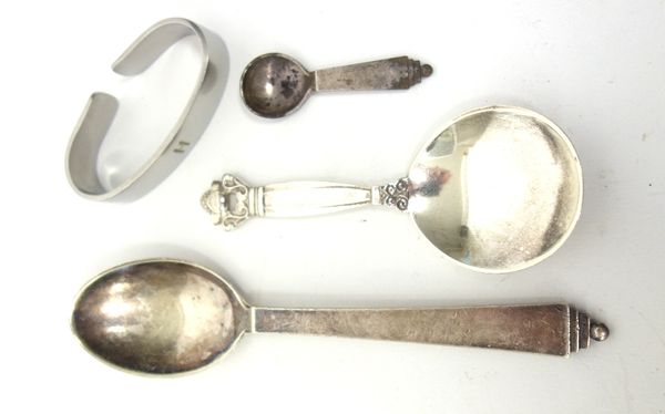 A Georg Jensen silver tea caddy spoon, detailed Sterling Denmark, import mark London 1938, a Georg Jensen Sterling christening spoon, detailed Sterlin