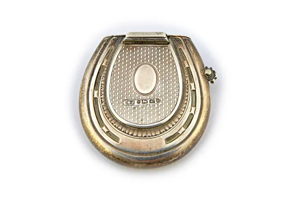 A Victorian silver vesta case cum lighter, of horseshoe form to both sides, the centre engine turned and with a vacant oval cartouche, the top hinged