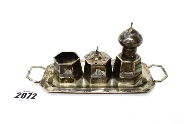 A Middle Eastern niello decorated condiment set, comprising; a pepper pot, a salt and a mustard pot, each piece of tapering hexagonal form and a twin