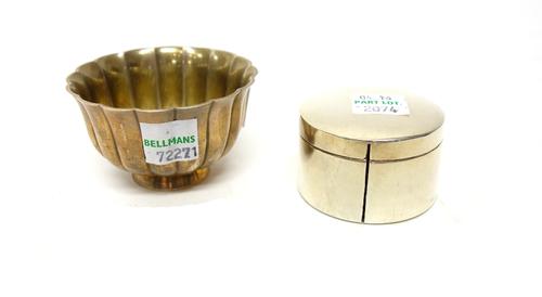 A Tiffany & Co Sterling circular hinge lidded tape dispensing box, gilt within and a small circular bowl detailed Bvlgari, London 1998, with fluted de