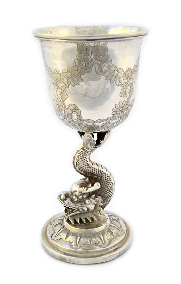 An Oriental goblet, the stem formed as a dragon, the bowl decorated with floral and foliate swags, on a circular foot, height 15.5cm (loaded).  Illust