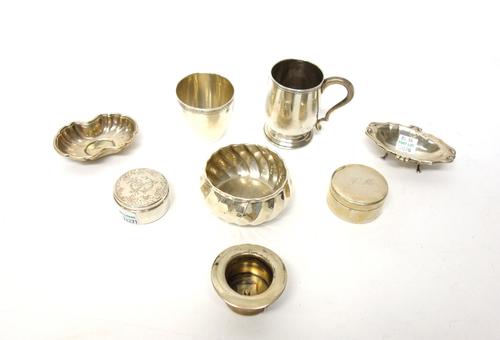 European 800 wares, comprising; a christening mug, a dish raised on four feet, a shaped oval dish, a circular bowl, having spiral fluted decoration, a