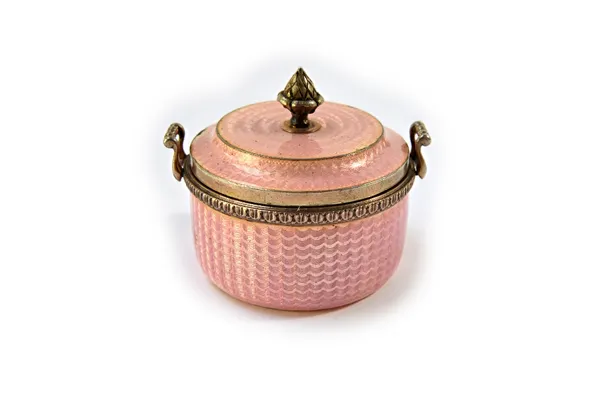 A copy of a Faberge twin handled miniature bowl, with a detachable cover, the exterior with pale pink engine turned enamelled decoration, the base mou