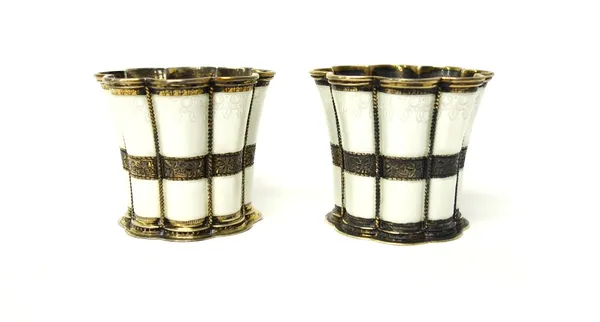 A pair of Danish silver gilt and white enamel beakers of flared form, detailed A. Michelsen, Copenhagen.