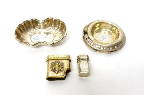 A hinge lidded cachou box, with engraved decoration, possibly Dutch, a Middle Eastern bangle converted for use as a dish, a parcel gilt lighter stand