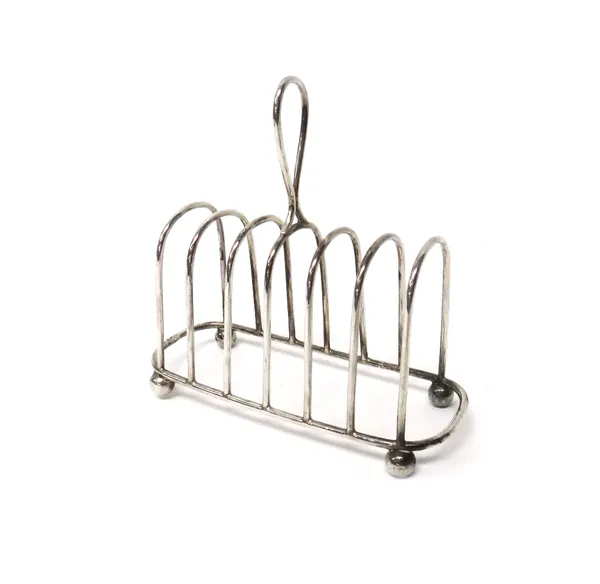 A late Victorian silver seven bar toastrack, with a loop shaped handle, raised on four spherical feet, Sheffield 1895, weight 186 gms.