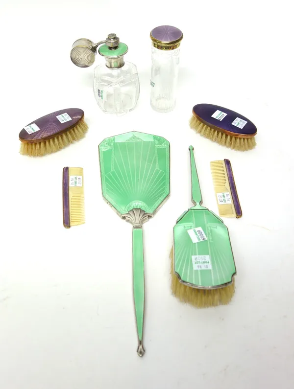 A silver and green enamel mounted hand mirror and a similar hairbrush, differing dates and designs, a faceted glass scent atomiser with a green enamel
