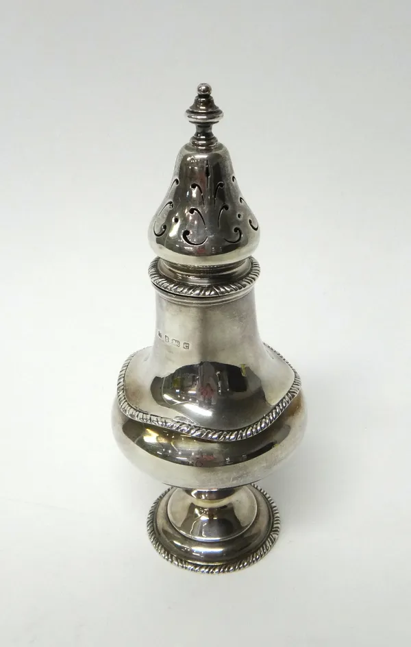 A silver sugar caster, of pear shaped form, decorated with gadrooned rims and on a circular foot, Birmingham 1902, weight 219 gms.