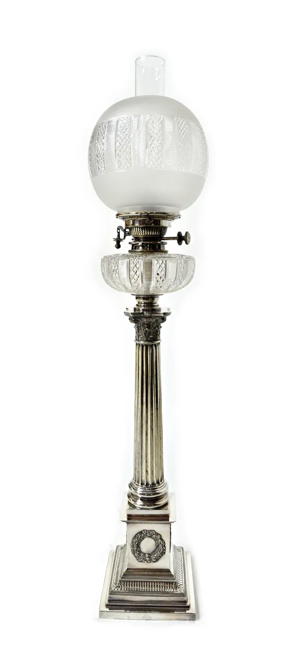 A Mappin & Webb silver plated and glass oil lamp, formed as a Corinthian column on a stepped square base, decorated with wreaths to the four sides, fi