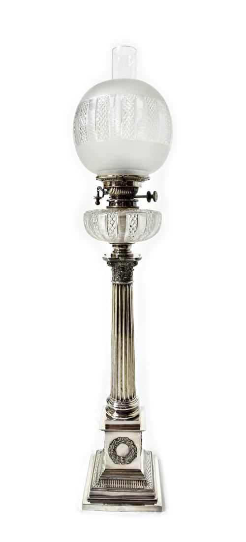 A Mappin & Webb silver plated and glass oil lamp, formed as a Corinthian column on a stepped square base, decorated with wreaths to the four sides, fi