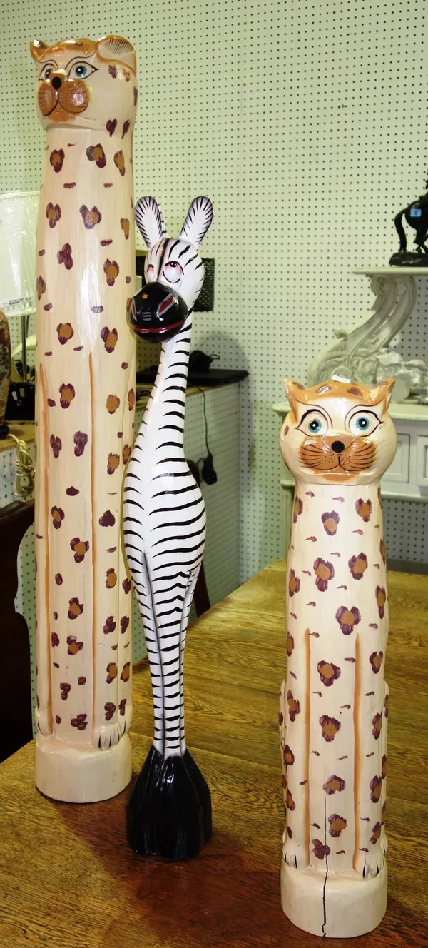 A 20th century tall carved wooden model of a cheetah, another similar and a giraffe. (3)