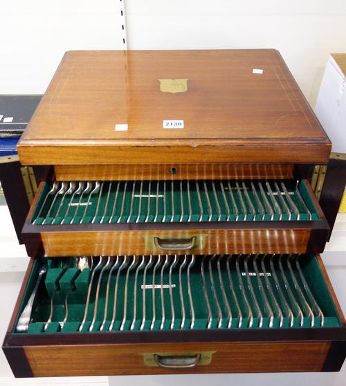 A plated canteen of table flatware for twelve place settings, including; a pair of gravy spoons, a soup ladle, a pair of sauce ladles, a pair of sugar