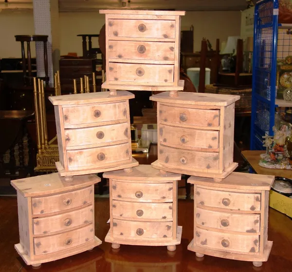 A group of six 20th century three drawer bowfront table top chests. (6)