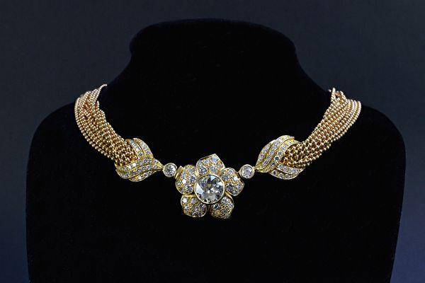 A gold and diamond floral necklace, the principal transition cut diamond weighing 3.88 cts centred within a flowerhead design, set with 95 round brill