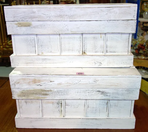 A pair of 20th century white painted lift top storage boxes. (2)