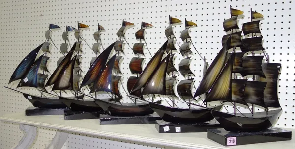 A group of five painted metal models of masted ships. (5)
