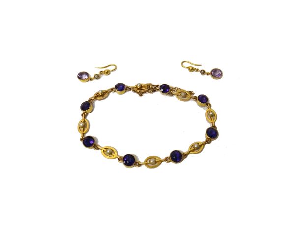 A gold, amethyst and half pearl set bracelet, collet set with a row of circular cut amethysts alternating with half pearl set oval links, on a snap cl