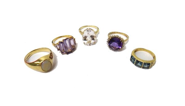 A 9ct gold ring, mounted with an oval opal, a 9ct gold ring, claw set with a circular cut amethyst at the centre, in a surround of small circular cut