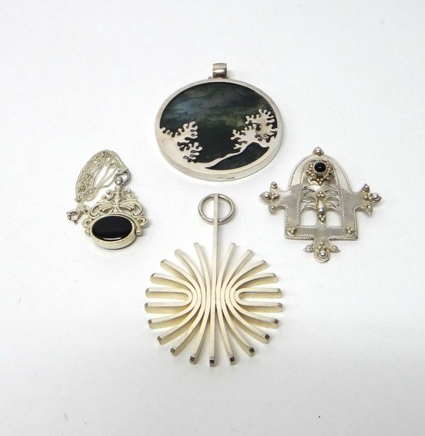 A Rudolf Heltzel of Kilkenny silver and moss agate pendant of circular form, with a chain, together with a Rudolf Heltzel of Kilkenny silver pendant o