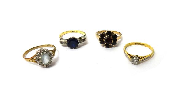 A gold and platinum, diamond set single stone ring, claw set with a cushion shaped diamond, a 9ct gold, oval cut pale blue gemstone and diamond set ov