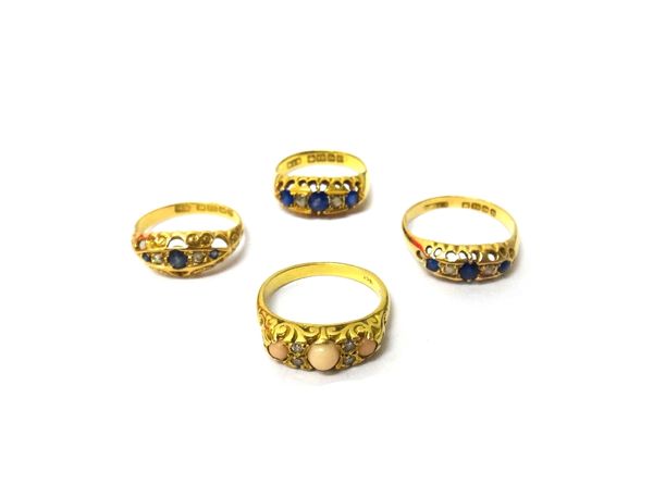 A gold ring, mounted with three corals and with two pairs of circular cut diamonds mounted at intervals, the mount decorated with scrolled sides, deta