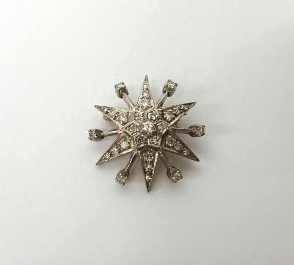 A diamond set brooch, designed as a six pointed star, with single stone diamond set points at intervals, mounted with circular cut diamonds.