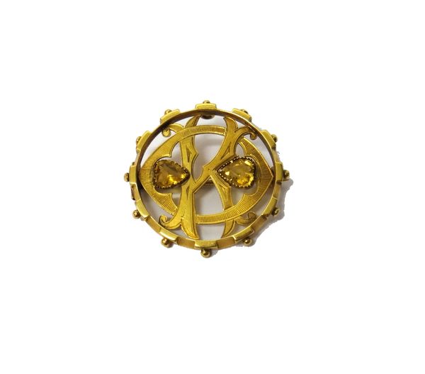 A Victorian 15ct gold and citrine set brooch, designed as a circular monogram, mounted with two heart shaped citrines, within a beaded border, Birming