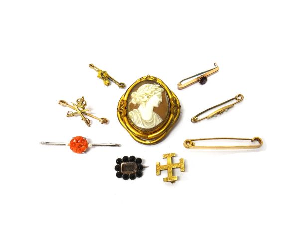 A white gold, carved coral and seed pearl set bar brooch, with floral motifs, a gold bar brooch, claw set with a circular cut garnet, a gold brooch, m