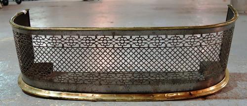 A brass and steel pierced fire guard.