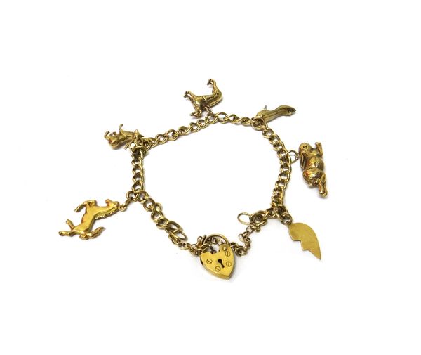 A gold curb link charm bracelet, with a 9ct gold heart shaped padlock clasp, fitted with six charms, including; a horse, a stag, a hare and a shoe, we