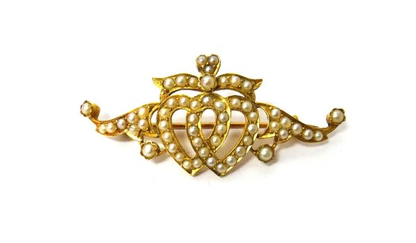 A Victorian gold and seed pearl set brooch, designed as two hearts with a bow surmount, detailed to the back J.B. 28.5.96, with a case.