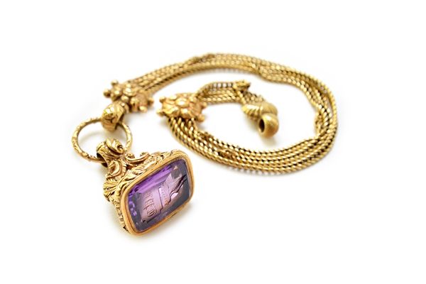 A Victorian gold and amethyst set pendant fob seal, seal engraved with a crest and a monogram, the mount with foliate and feathered decoration, with a