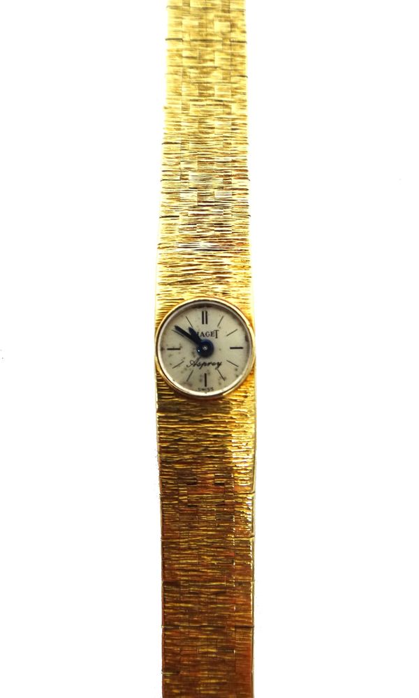 A lady's 18ct gold rear winding Piaget bracelet wristwatch, the signed circular silvered dial with baton shaped numerals, blued steel hands and signed