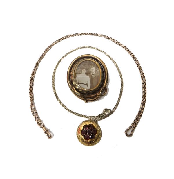 A Victorian gilt metal brooch, glazed with a photographic locket to the front and with a hair locket at the back, otherwise with a serpent motif, a go